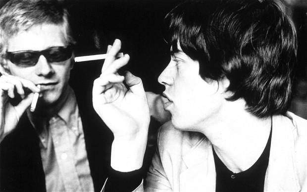 Andrew Oldham and Mick Jagger conferring in ‘64