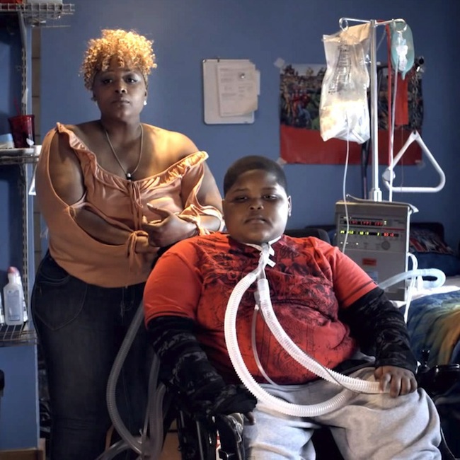 Valetta and her eight-year-old son Xzavier, ‘the Mighty X Man,’ paralyzed after being struck by a texting driver: ‘X is paralyzed from the diaphragm down. In the accident part of his spinal cord was dissipated. His legs are gone. His chair are his legs now….X is on life support. A ventilator has to breathe for my son….I can’t say ‘go play.’ Any mother understands. I can’t say ‘go play.’’