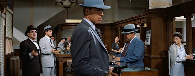 Bank robber Dill (Lee Marvin) at work in Violent Saturday. To his role Marvin ‘brings a multi-faceted complexity to the role and gives a great example of the early promise that launched his long and successful career,’ Film Noir of the Week.