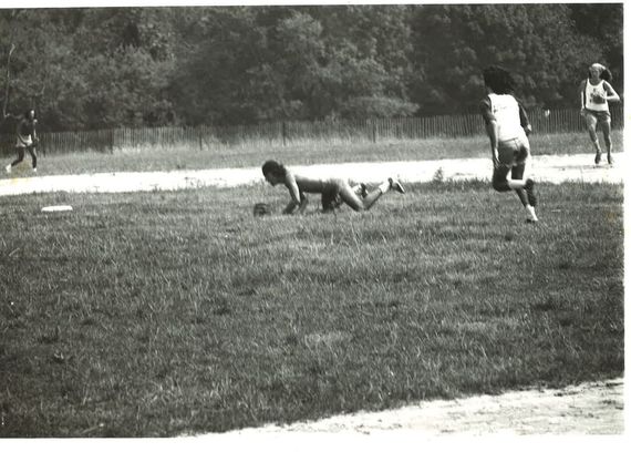 Bruce Springsteen, playing second base, diving in vain for a sharply hit ball through the infield. That's Flashmaker (Steven ‘Buck’) Baker running to second base. In the outfield, Bruce roadie Natty Dread moves in to field the ground ball. (Photo: Ira Mayer)