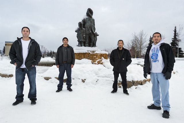 The Fairbanks Four (from left): Kevin Pease, Eugene Vent, George Frese, and Marvin Roberts stand in front of Malcolm Alexander’s Unknown First Family sculpture. ‘Their true crime was diversity: Alaska Natives and a Native American, this quartet looked as people of privilege felt—and persist in feeling—that criminals look.’ (Photo: Keri Oberly, published in Pacific Standard) 